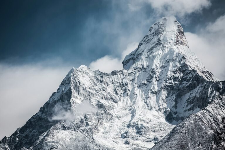 Snow-covered Mount Everest peak highlighting the breathtaking yet challenging journey to Everest Base Camp