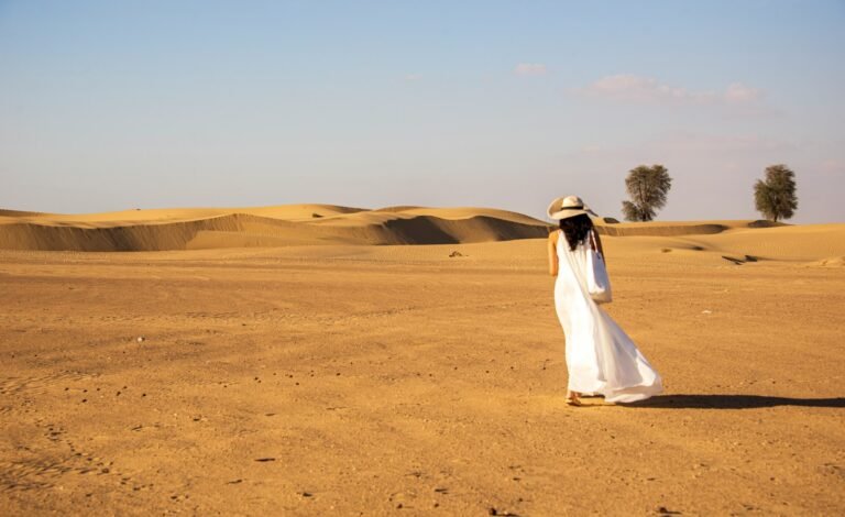 Woman wearing a white dress in the desert